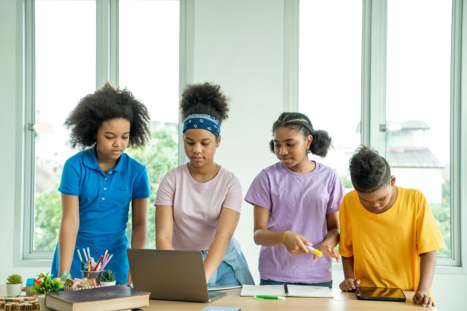 Four children with a laptop